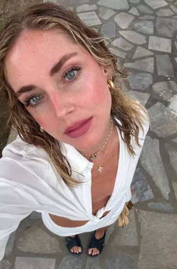 Chiara Ferragni Classic Cross Pendant Necklace in Gold worn by Chiara Ferragni on her Instagram Story on August 10, 2024