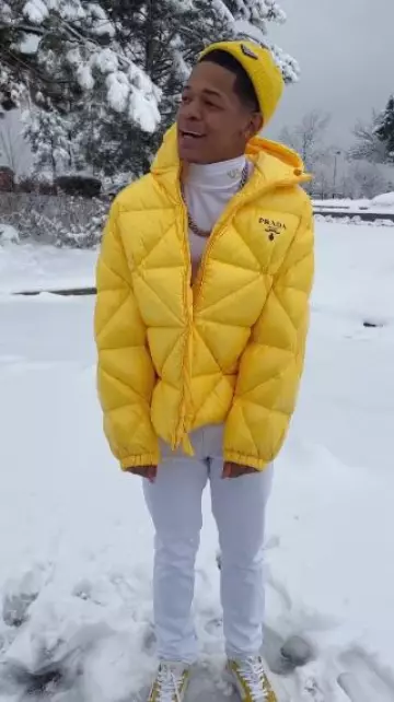 Prada Yellow Triangle Quilted Puffer Jacket worn by YK Osiris on the Instagram account @ykosiris
