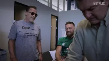 Outfits of McGREGOR FOREVER: Arnold Schwarzenegger wears "Opa German" t-shirt in season 1