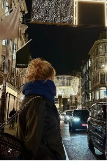 Chanel Shiny Crumpled Lambskin & Gold-Tone Metal Small Camera Case in Black worn by Lucy Boynton on her Instagram Post on November 15, 2024