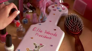 Accessories of Legally Blonde: Elle Woods (Reese Witherspoon) uses Frederic Fekkai Hair Brush in the movie