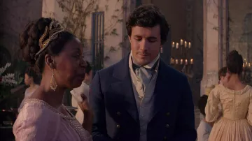 Costumes of The Little Mermaid: Eric (Jonah Hauer-King) wears Blue jacket with golden accents, a white jumpsuit and pants in the movie