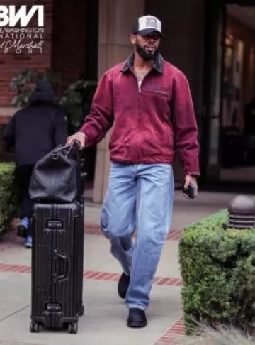 Rimowa Black Aluminum Check In Large Suitcase worn by Rashod Bateman on the Instagram account @ravens