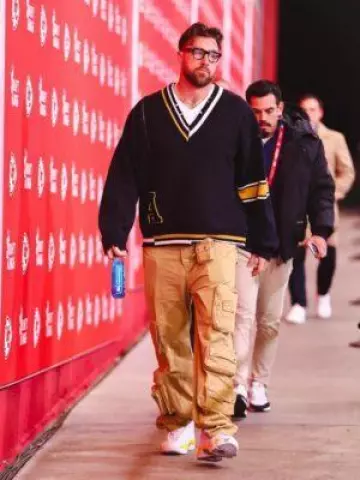 Ambush Black A Patch Asymmetric V Neck Sweater worn by Travis Kelce on the Instagram account @chiefs