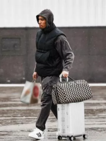 Rimowa Silver Cabin Suitcase worn by Amon-Ra St. Brown on the Instagram account @detroitlionsnfl