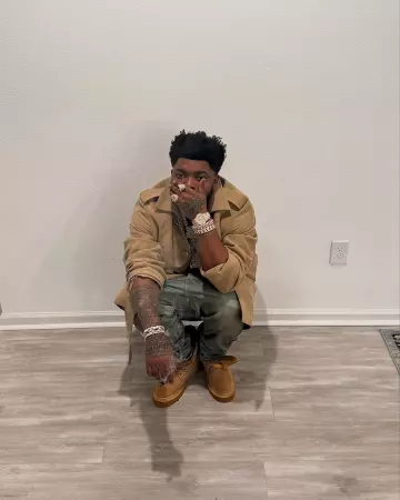 Louis Vuitton Beige Mini Monogram LV Ranger Boots worn by BossMan Dlow on the Instagram account @bossman_dlow