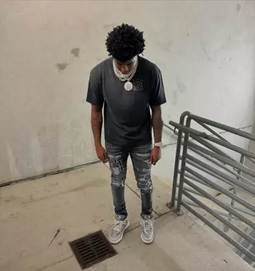 Amiri Storm Grey Staggered Logo 'Repair' Jeans worn by Yungeen Ace on the Instagram account @yungeenace