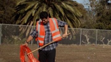 the orange vest of Walter O'brien (Elyes Gabel) in Scorpio
