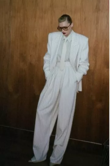 Helsa Pinstripe High Waist Pleated Suit Trouser in Ivory & Brown Stripe worn by Elsa Hosk on her Instagram Story on January 22, 2025