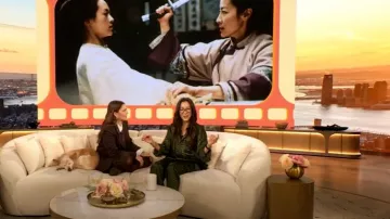 Balenciaga Printed Silk Satin Wide-leg Pants worn by Michelle Yeoh as seen in The Drew Barrymore Show on February 3, 2025