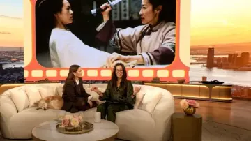 Balenciaga Printed Silk Satin Wide-leg Pants worn by Michelle Yeoh as seen in The Drew Barrymore Show on February 3, 2025