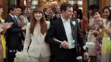 Pink blazer, pink pants and white blouse worn by Anastasia Steele (Dakota Johnson) in Fifty Shades Freed movie wardrobe