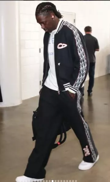 Dior x KAWS Navy CD-Logo Bomber Jacket worn by Jrue Holiday on the Instagram account @nbafashionfits