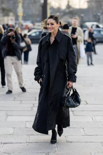 Trench-coat Dior noir moiré porté par Olivia Palermo au défilé Dior à Paris le 4 mars 2025