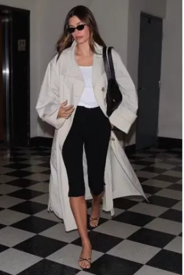 Mango Oversized Cotton Trench Coat worn by Hailey Bieber in Sushi Park post on April 17, 2025