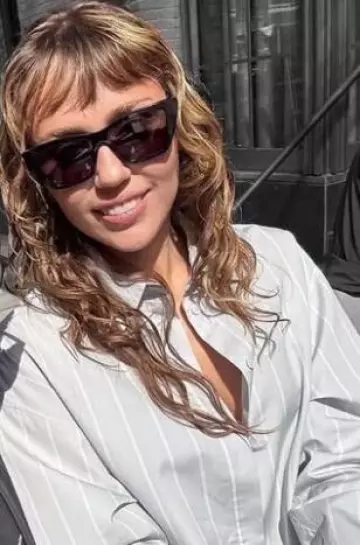 Proenza Schouler Addy Cotton Silk Oversized Striped Button Down Top worn by Miley Cyrus at  Fan Photo on  April 24, 2025