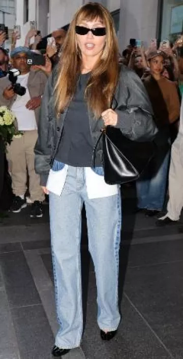 Alaia Le Click East West Large Bag in Leather worn by Miley Cyrus in  New York City on May 3, 2025
