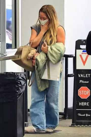 Alaia Patent Leather-Trimmed Mesh Ballet Flats in White worn by Hilary Duff in Beverly Hills on May 9, 2025