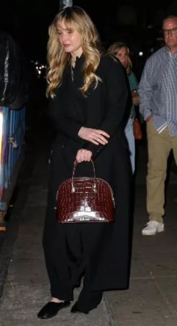 The Row Lady Bag in Shiny Alligator Burgundy worn by Jennifer Lawrence in New York City on May 31, 2025