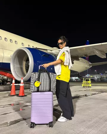 Beis the Vacation Tote in Black Stripe worn by Shay Mitchell on her Instagram Story on August 23, 2024