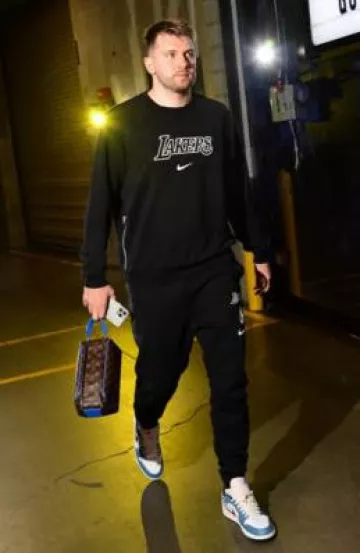 Louis Vuitton Brown Monogram & Blue Trim Toiletry Bag worn by Luka Dončić on the Instagram account @nbafashionfits