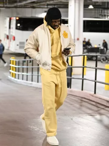 Rhude White & Yellow Battery Effect Varsity Jacket worn by Jrue Holiday on the Instagram account @celtics