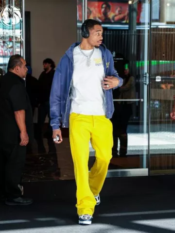 Gallery Dept. Yellow Flared Logan Jeans worn by Paul Jamaine Washington Jr. on the Instagram account @dallasmavs