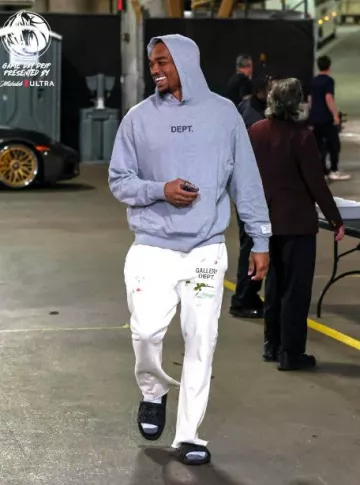 Gallery Dept. Cream Paint Splatter Flared Sweatpants worn by Paul Jamaine Washington Jr. on the Instagram account @dallasmavs