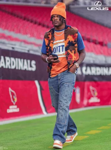 Louis Vuitton White & Orange Damier 'LV Trainer' Sneakers worn by Lamar Jackson on the Instagram account @ravens