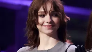 Wednesday S2 Emma Myers Outcast Assembly Grey Sweater worn by Enid Sinclair (Emma Myers) as seen in Wednesday (S02E07)