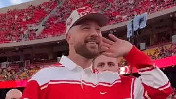 This Red & White Striped Rugby Shirt worn by Travis Kelce in Travis Kelce & Taylor Swift attend Cincinnati's 2025 season opener against Nebraska