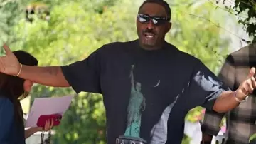 82nd Venice International Film Festival Black Graphic T-Shirt worn by Idris Elba in Idris Elba with Sabrina Elba at the 82nd Venice Film Festival. #idriselba