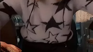 Black Star Printed Sweater worn by Taylor (Alexandra Breckenridge) in My Secret Santa