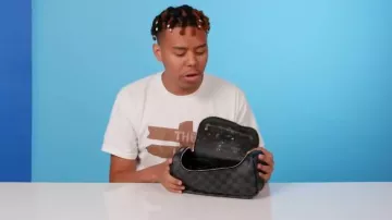 Louis Vuitton Graphite Damier Toiletry Bag worn by YBN Cordae in 10 Things YBN Cordae Can't Live Without | GQ