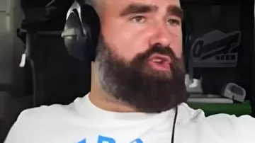 New Height Show White Graphic T-Shirt worn by Travis Kelce as seen in New Heights with Jason and Travis Kelce