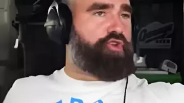 New Height Show White Graphic T-Shirt worn by Travis Kelce as seen in New Heights with Jason and Travis Kelce