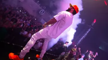 Louis Vuitton Orange Millenium Sneakers worn by El Alfa in El Alfa El Jefe x Gordo - El Mas Chingon