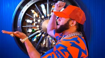 Amiri x Zig Zag Orange Logo Trucker Hat worn by El Alfa in El Alfa El Jefe x Papa Jeison - Moli