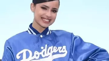 Sofia Carson Dodgers Blue Sartin Jacket in the music video Comedians Who Humiliated Ellen Degeneres On Her Own Show