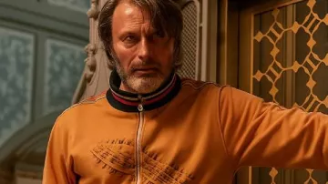 Dust Bunny 2025 Mads Mikkelsen Orange Tracksuit worn by (Mads Mikkelsen) in Dust Bunny