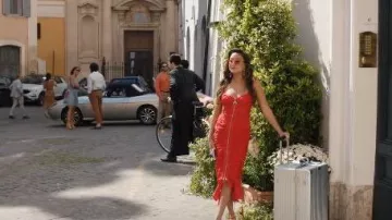 Serpui Mia Flamingo Beaded Straw Clutch Bag worn by Mindy Chen (Ashley Park) as seen in Emily in Paris (S05E02)