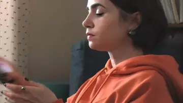 Emily In Paris S05 Lily Collins Orange Slogan Hoodie worn by Emily Cooper (Lily Collins) as seen in Emily in Paris (S05)