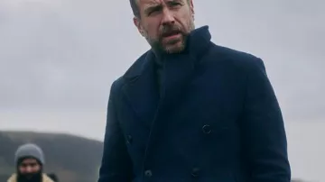 Rafe Spall Under Salt Marsh 2026 Blue Coat of Eric Bull (Rafe Spall) in Under Salt Marsh (S01E01)