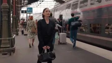 Ferragamo Folded Handbag in Black worn by Emily Cooper (Lily Collins) as seen in Emily in Paris (S05E09)