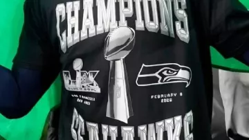 Champions Shirt worn by Sam Darnold in Cooper Kupp and Leonard Williams react to winning Super Bowl LX