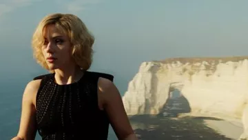 The downstream cliff of Etretat in Upper Normandy in the background of Lucy (Scarlett Johansson) in the film Lucy