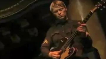 The badge of military on the jacket of the guitarist of Cake for the live I Will Survive