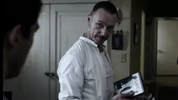 The DVD of the film The Associates of the Father Marcus (Ben Daniels) in The Exorcist S01E02