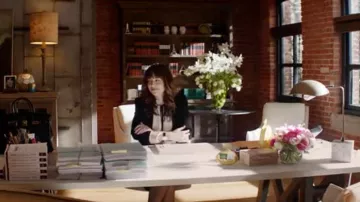 The blouse with a knot at the neck of Anastasia Steele (Dakota Johnson) in Fifty shades lighter