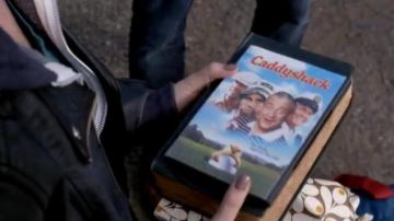The DVD of Caddyshack that offers Dean Winchester (Jensen Ackles) Claire Novak (Sydney Imbeau) in Supernatural S10E20